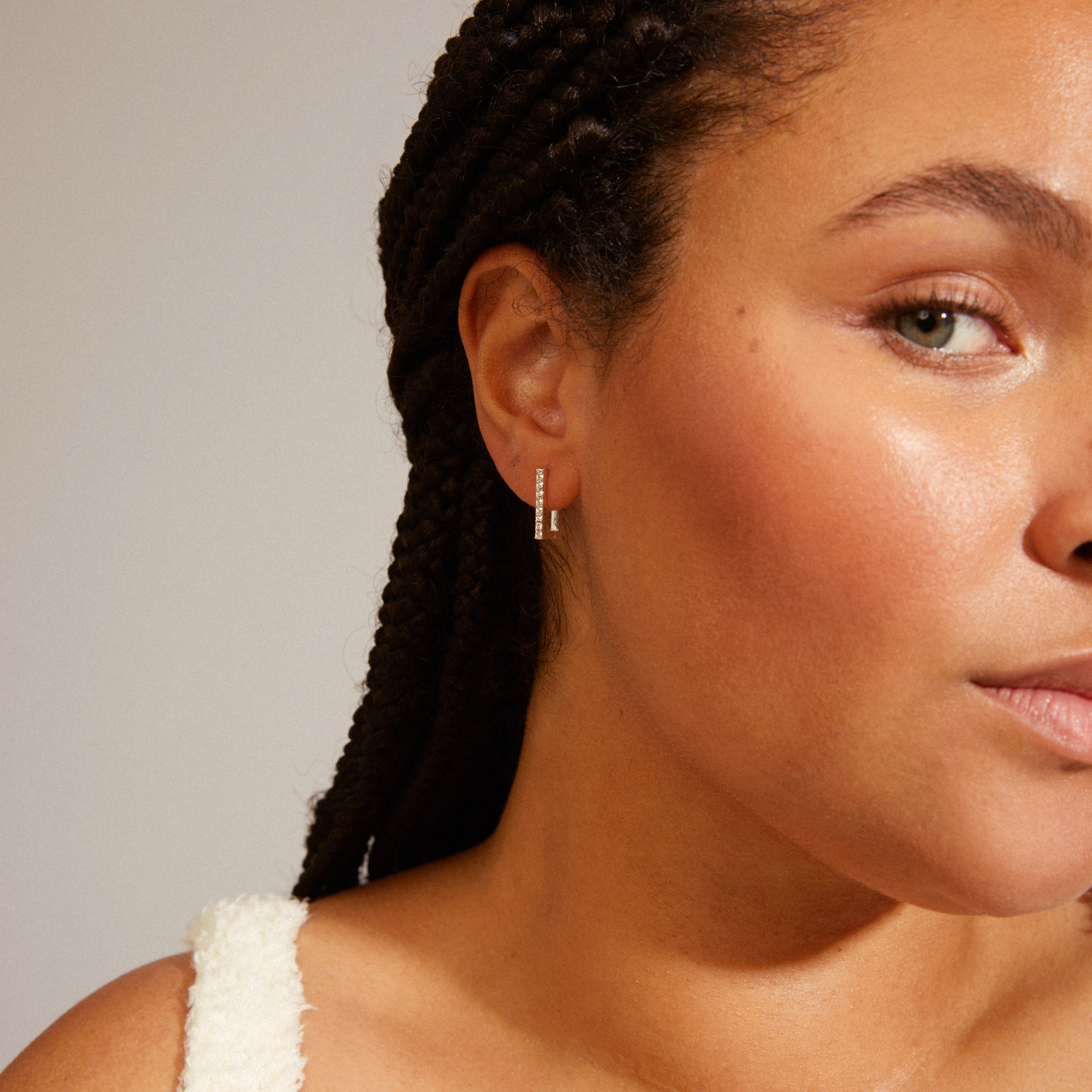 COBY crystal square hoop earrings silver-plated, worn by a woman with braids. The earrings feature Preciosa crystals and an easy click lock for a retro vibe.