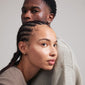 Man and woman showcasing ARLET gold-plated heart stud earrings, highlighting their versatile, rustic design ideal for gifting or personal style.