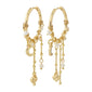 Gold-plated ARLET hoop earrings adorned with freshwater pearls, Preciosa crystals, moon pendants, and hearts, offering a romantic boho-lux vibe.