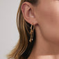 ARLET gold-plated hoop earrings by Pilgrim on ear; one plain, one with wire, pearls, dangling chains, charms, adding a boho-lux romantic flair.