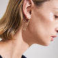 Close-up of a woman wearing ARLET gold-plated hoop earrings with freshwater pearl and Preciosa crystals, featuring tiny moon pendants and hearts.