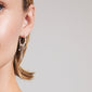 ARLET earrings silver-plated on ear, featuring freshwater pearls, Preciosa crystals, and moon and heart charms, showcasing a boho-lux aesthetic from Pilgrim.