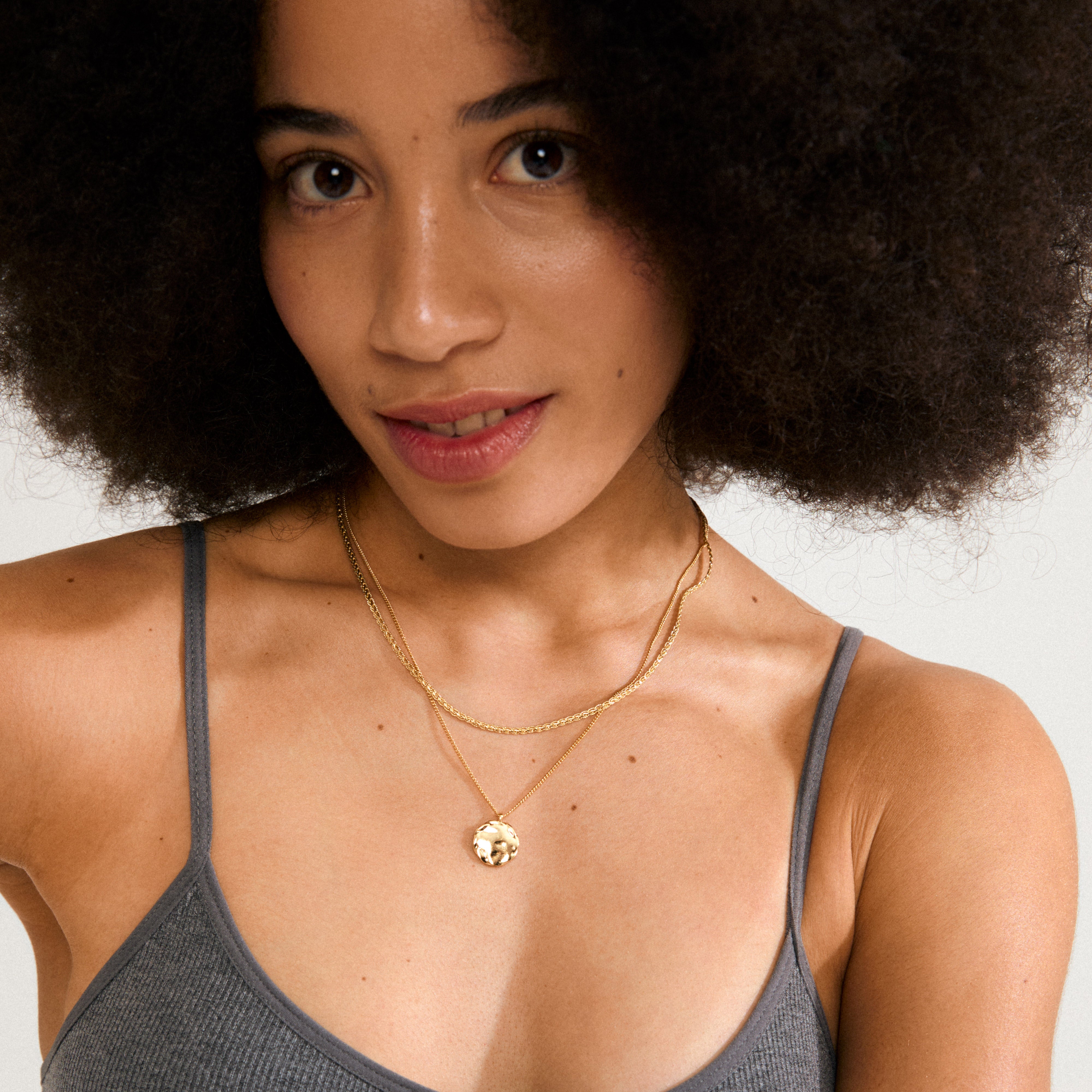 DECLAN necklace set, gold-plated, featuring a braided chain and a coin chain with pendant, perfect for layering or individual wear, crafted from 99% recycled material.