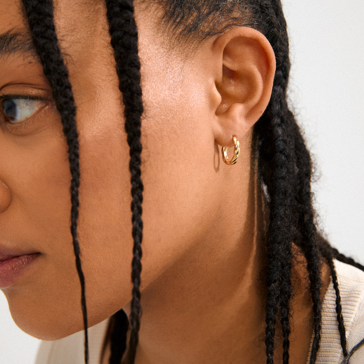 DECLAN gold-plated hoops by Pilgrim, featuring twisted details and click clasps, crafted from 99% recycled materials for a timeless yet trendy look.