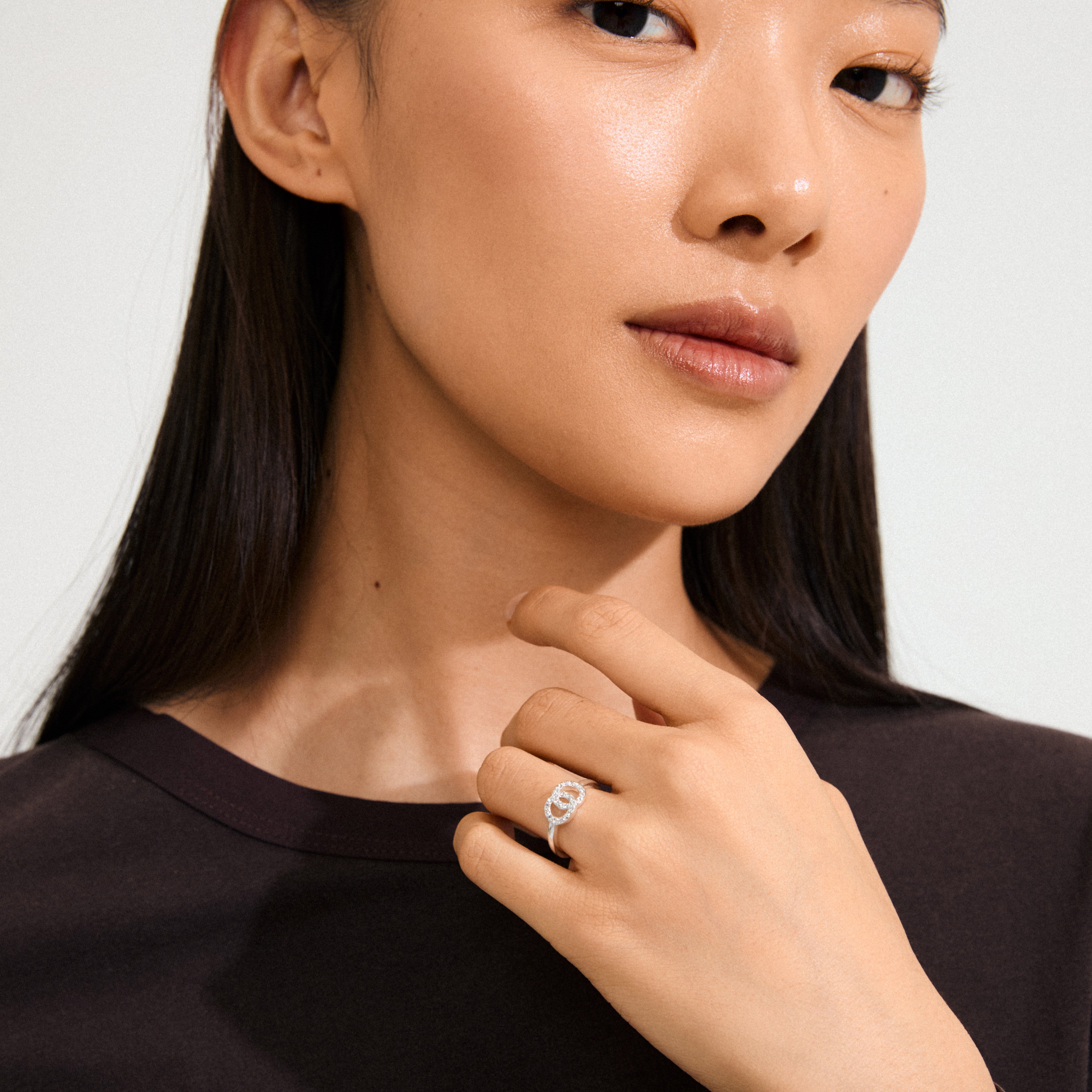 LULU halos stack ring, silver-plated, featuring two crystal-adorned intertwined circles symbolizing connection and balance, crafted from 93% recycled materials for a chic, eco-friendly look.