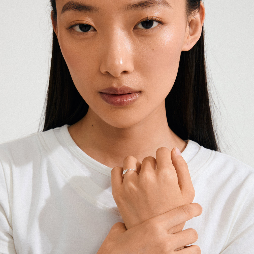 Close-up of a woman wearing the silver-plated Lulu mom stack ring, highlighting its simple, elegant design, a tribute to love and family.