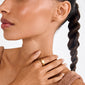 Woman wearing Pilgrim's ARIN gold-plated signet ring with a minimalist heart design, resting on her collarbone, paired with a sleeveless knit top.
