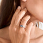 Close-up of a hand wearing the ARIN ring silver-plated by Pilgrim, featuring a heart-shaped face on a polished silver signet, exemplifying minimalist elegance.