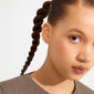 Young woman wearing EDIE crystal heart earrings, gold-plated, with tiny sparkling stones, adding a touch of glam and romance to her chic, minimalist look.