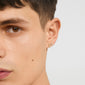 EDIE crystal heart earrings gold-plated, featuring tiny sparkling stones on a young person's ear, showcasing delicate glam with a romantic touch.