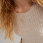 IBEN tree-of-life necklace gold-plated, featuring a round pendant with Preciosa crystals, worn by a woman, showcasing Pilgrim's blend of timeless style and meaningful design.