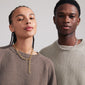 AMIRI necklace gold-plated on a person, showcasing a modern cable chain design with Preciosa crystals, highlighting timeless elegance and genderless appeal.