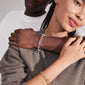 AMIRI gold-plated bracelet with fluid cable chain design, adorned with sparkling Preciosa crystals, styled for an urban, genderless look.