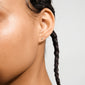 CAILY crystal earrings gold-plated, featuring three tiny stones in a triangular cluster on a pierced ear, embody elegance and subtlety, perfect for complementing feminine outfits.