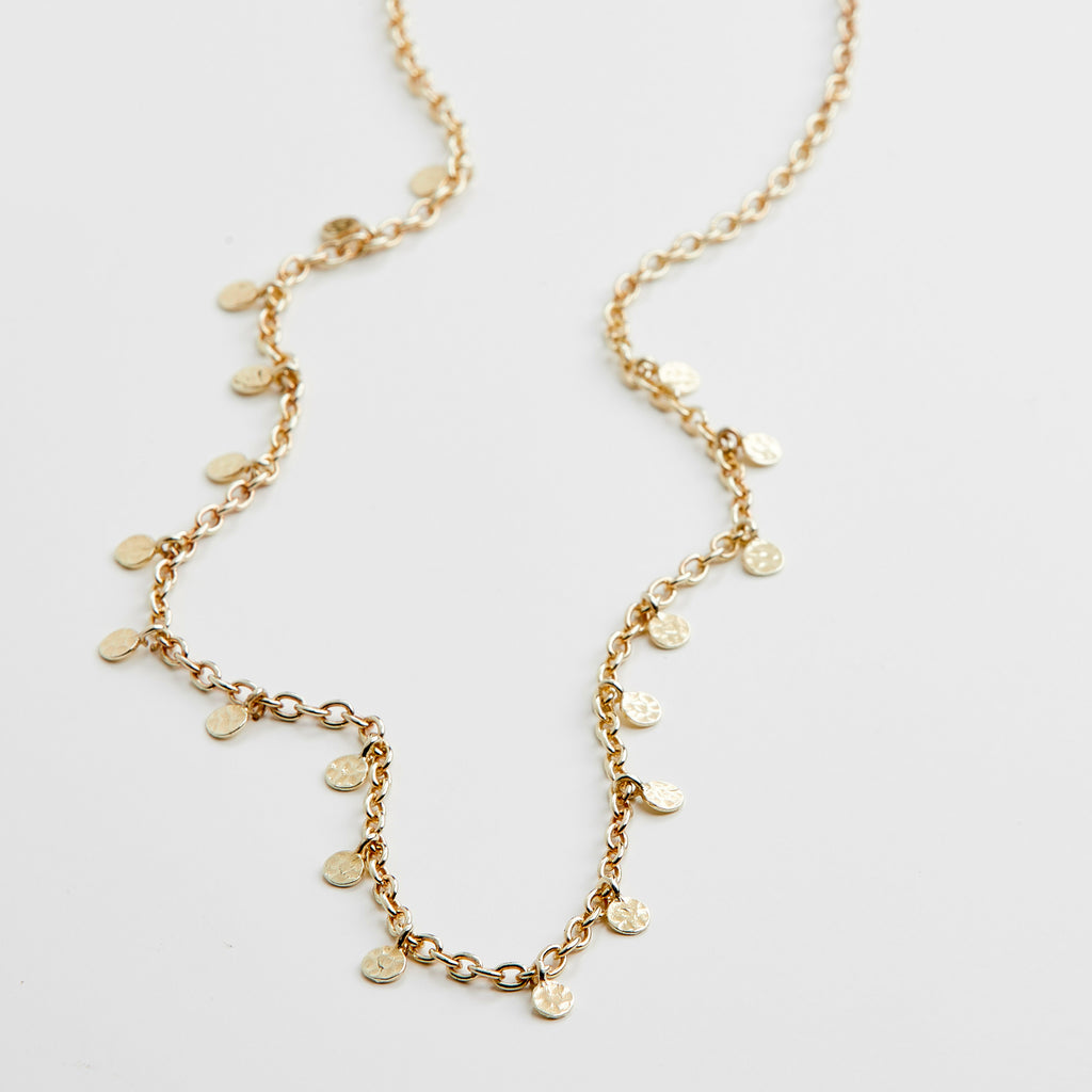 PANNA coin necklace gold-plated features small round pendants on a delicate chain, exemplifying a blend of classic and trendy Scandinavian design.