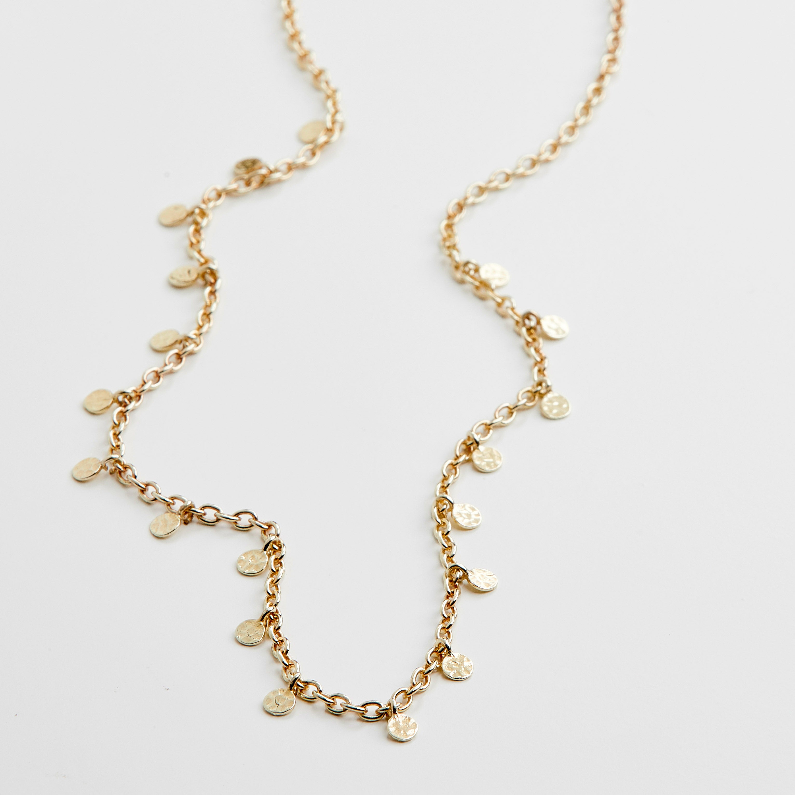 PANNA coin necklace gold-plated features small round pendants on a delicate chain, exemplifying a blend of classic and trendy Scandinavian design.