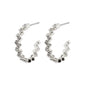 JOLENE wavy crystal hoop earrings, silver-plated, featuring a raw, squared design with elegant Preciosa crystals, reflecting an urban and high-class style.