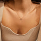 TINA crystal pendant necklace gold-plated, featuring a delicate recycled gold chain with an asymmetrical pendant and Preciosa crystal, worn above the collarbone.