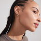 ZHURI earrings 2-in-1 set gold-plated, showcasing floral half-hoops and studs on a woman with braids, highlighting Pilgrim's trendy, inclusive design.