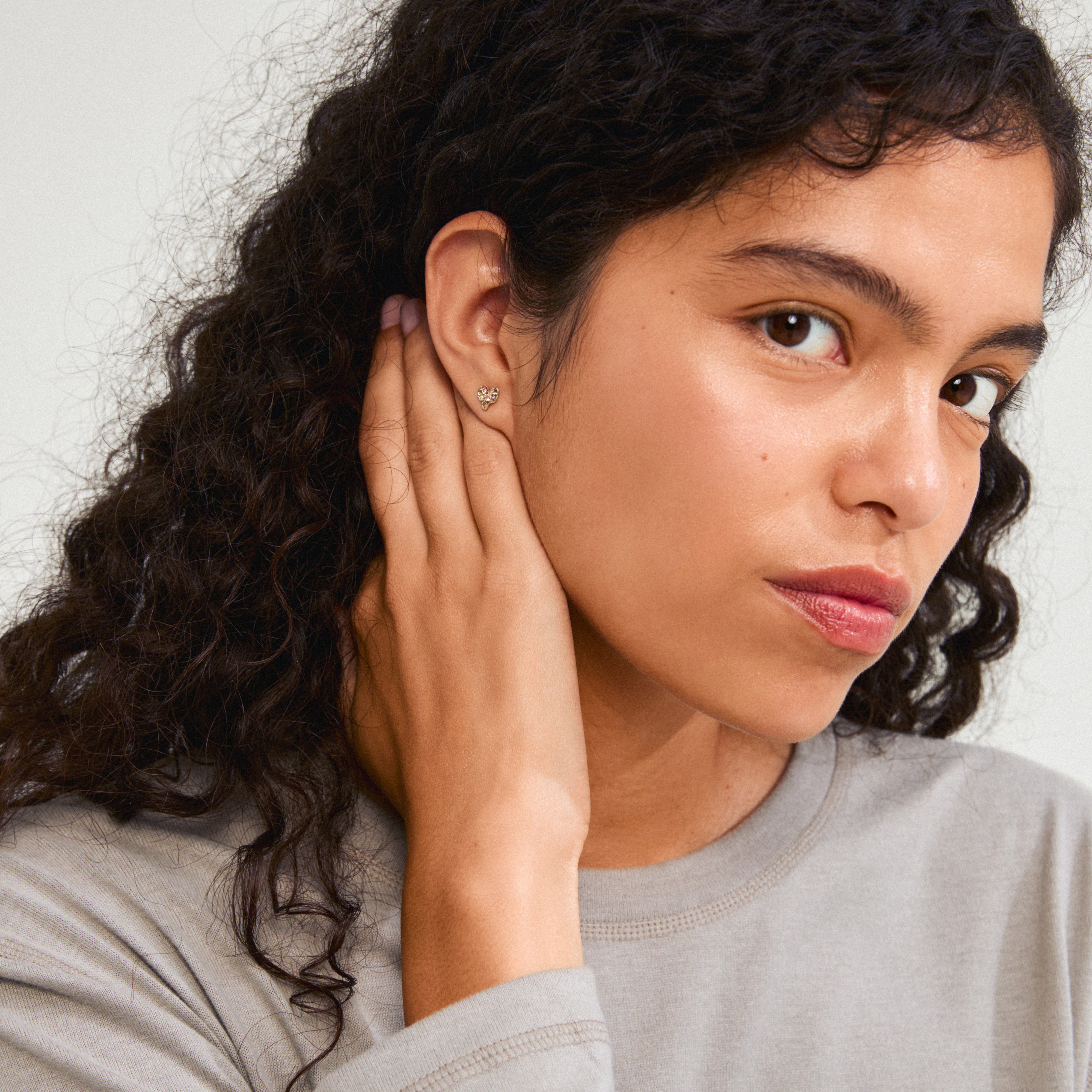 Woman wearing RYAN heart earrings, gold-plated and handcrafted by Pilgrim, highlighting their elegant, organic shape and romantic design.
