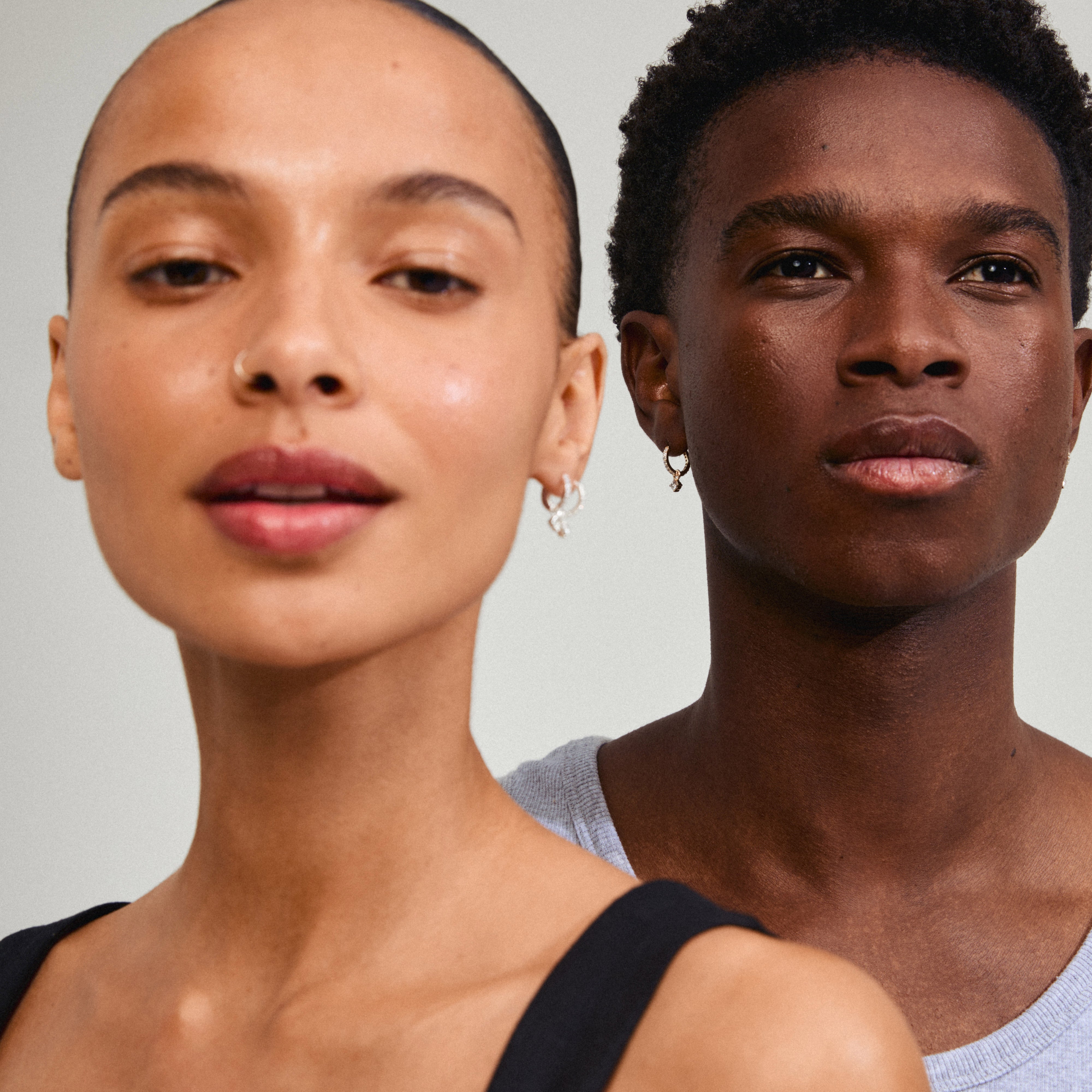 JOA crystal hoop earrings, silver-plated, featuring Preciosa crystals with a dangling pendant, elegantly worn by a woman, showcasing Pilgrim's timeless Scandinavian design.