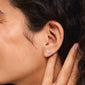 RYAN heart earrings silver-plated, showcasing elegant, organic heart shapes with brightly colored crystals, worn close-up on a woman's ear.