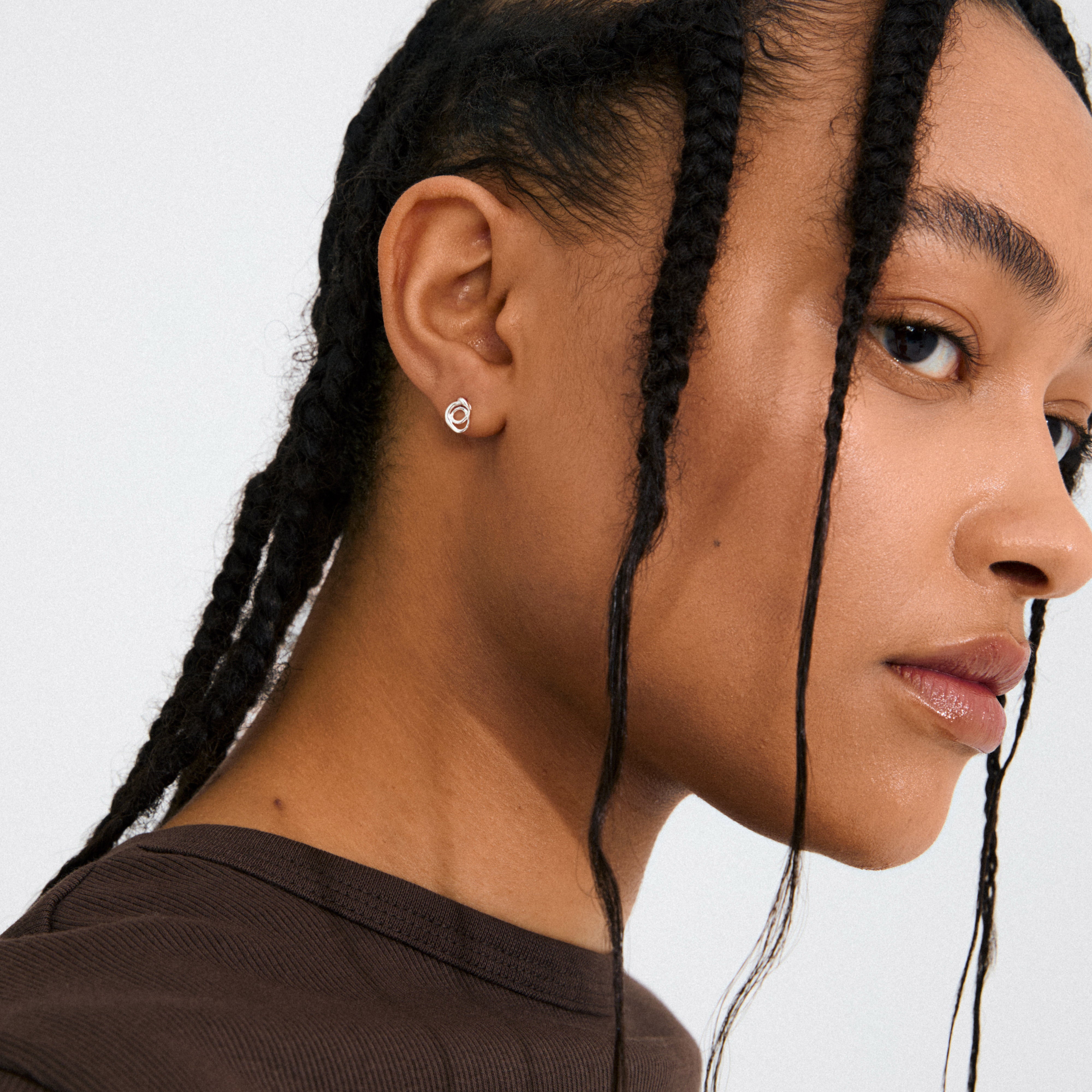 Silver-plated DIEGO earrings with fluid doodle design, offering a playful, artistic touch. Crafted from 99% recycled materials, reflecting Pilgrim's trendy, sustainable ethos.