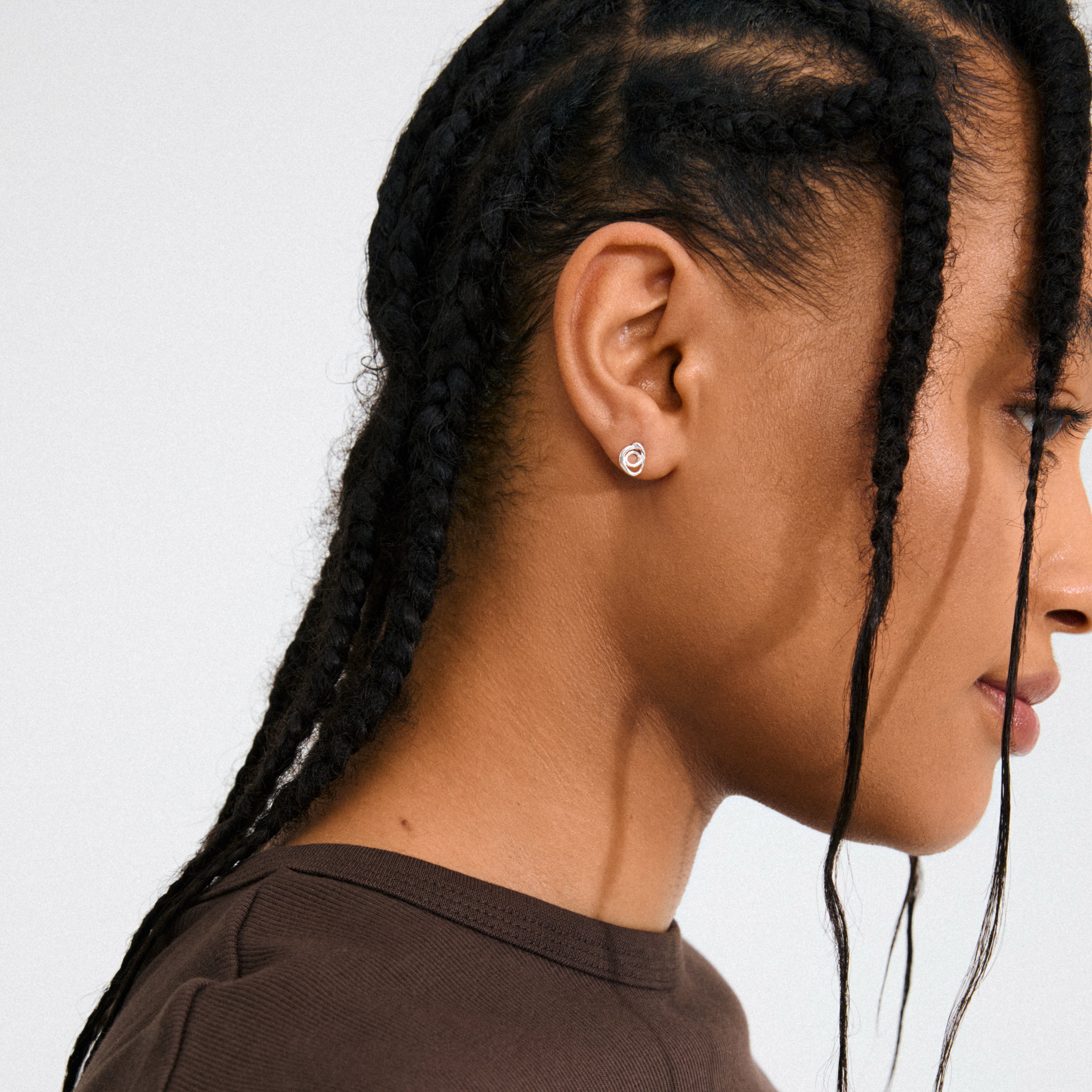 Silver-plated DIEGO earrings by Pilgrim featuring a fluid doodle design, offering a playful, artistic touch for statement style with 99% recycled materials.