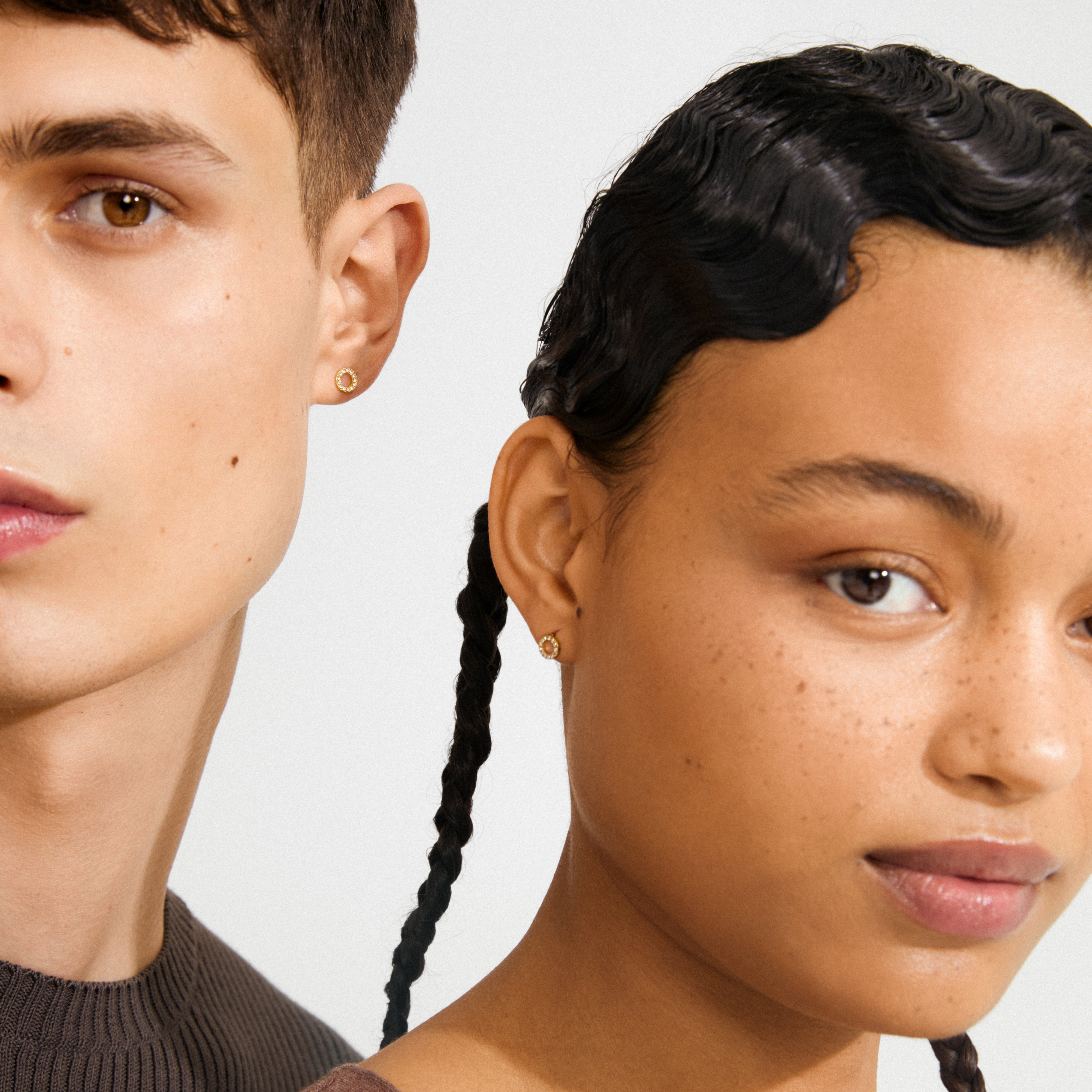 Two models showcase TESSA crystal halo earrings gold-plated, featuring circular motifs with Preciosa crystals, highlighting their timeless elegance and subtle glamour.