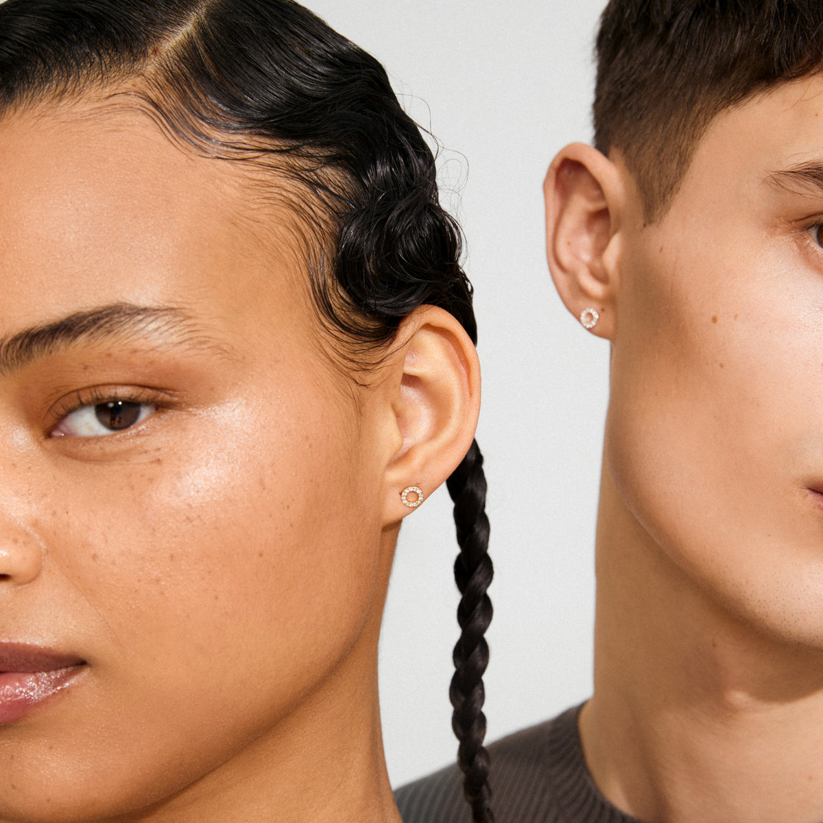 Close-up of two individuals wearing TESSA crystal halo gold-plated earrings, featuring delicate circular designs set with sparkling Preciosa crystals, highlighting their subtle elegance.