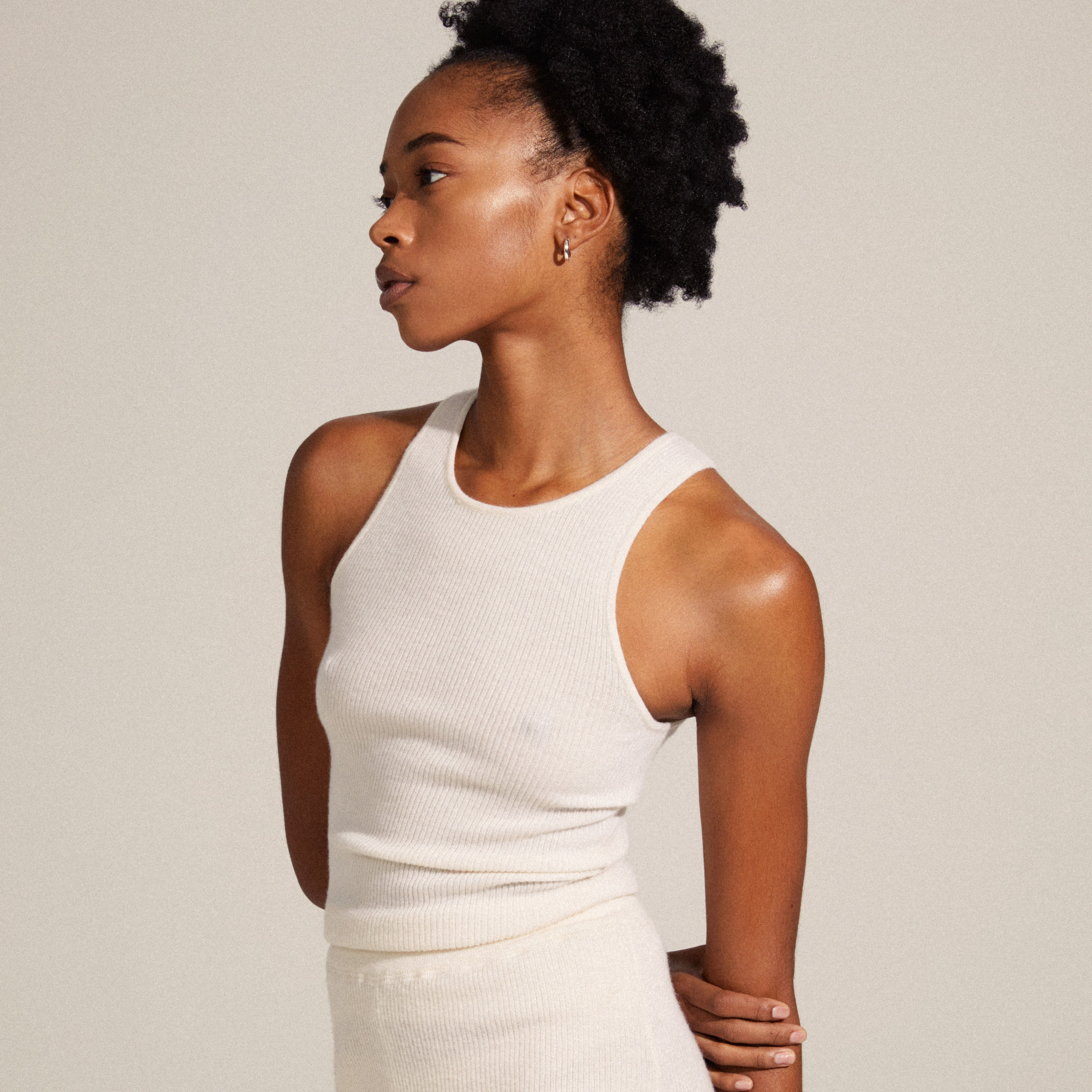 Woman wearing TYRA chunky hoop earrings, silver-plated, from Pilgrim. Showcases simple, stylish design, part of the sustainable recycled collection.