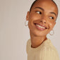 Woman wearing EDDY organic shaped maxi hoops silver-plated, showcasing their elegant, wavy design. The earrings exude a handcrafted, stylish vibe, perfect for any adventure.