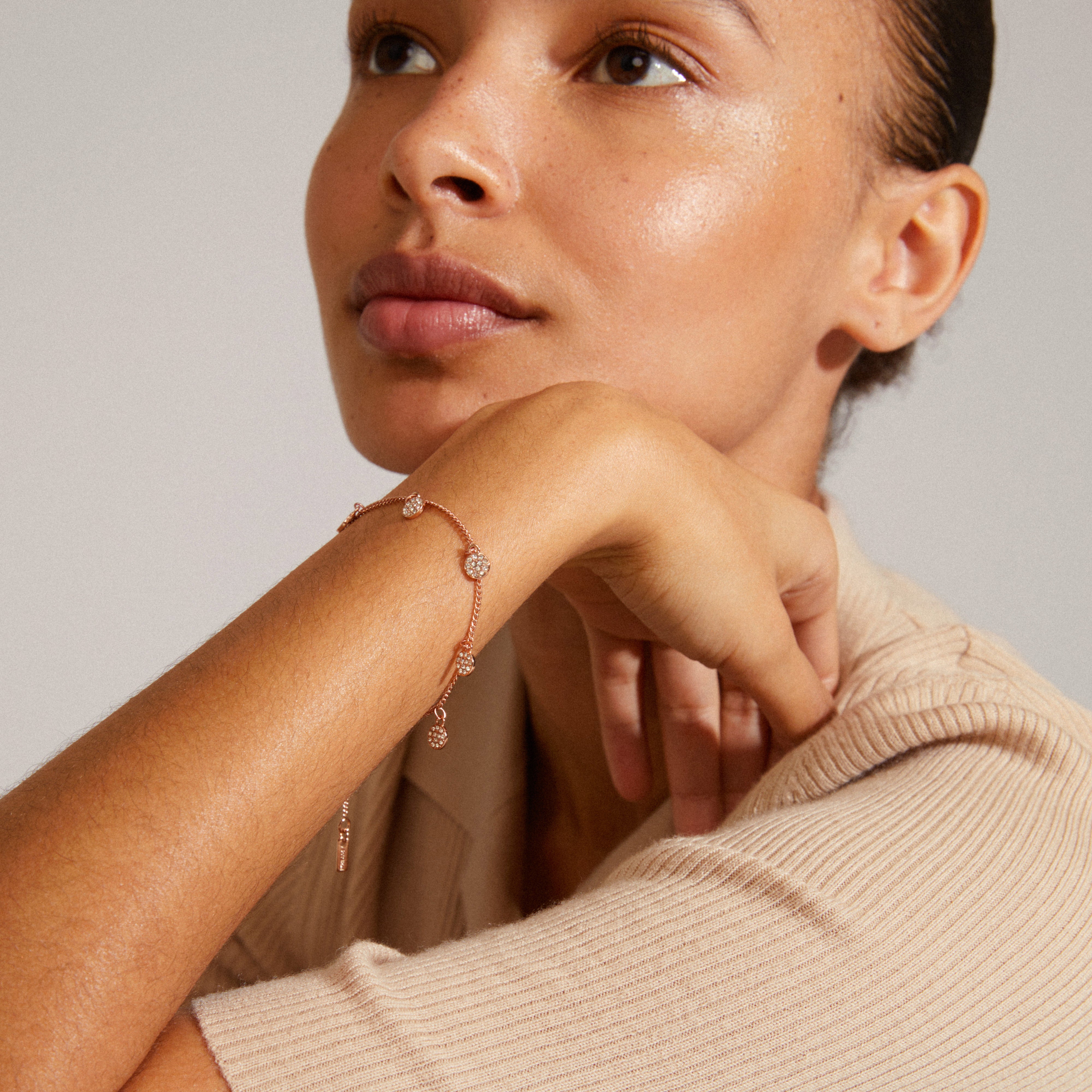 CHAYENNE crystal bracelet rosegold-plated on woman's wrist, highlighting slim chain and coin pendants with Preciosa crystals, reflecting Pilgrim's elegant and sustainable design.