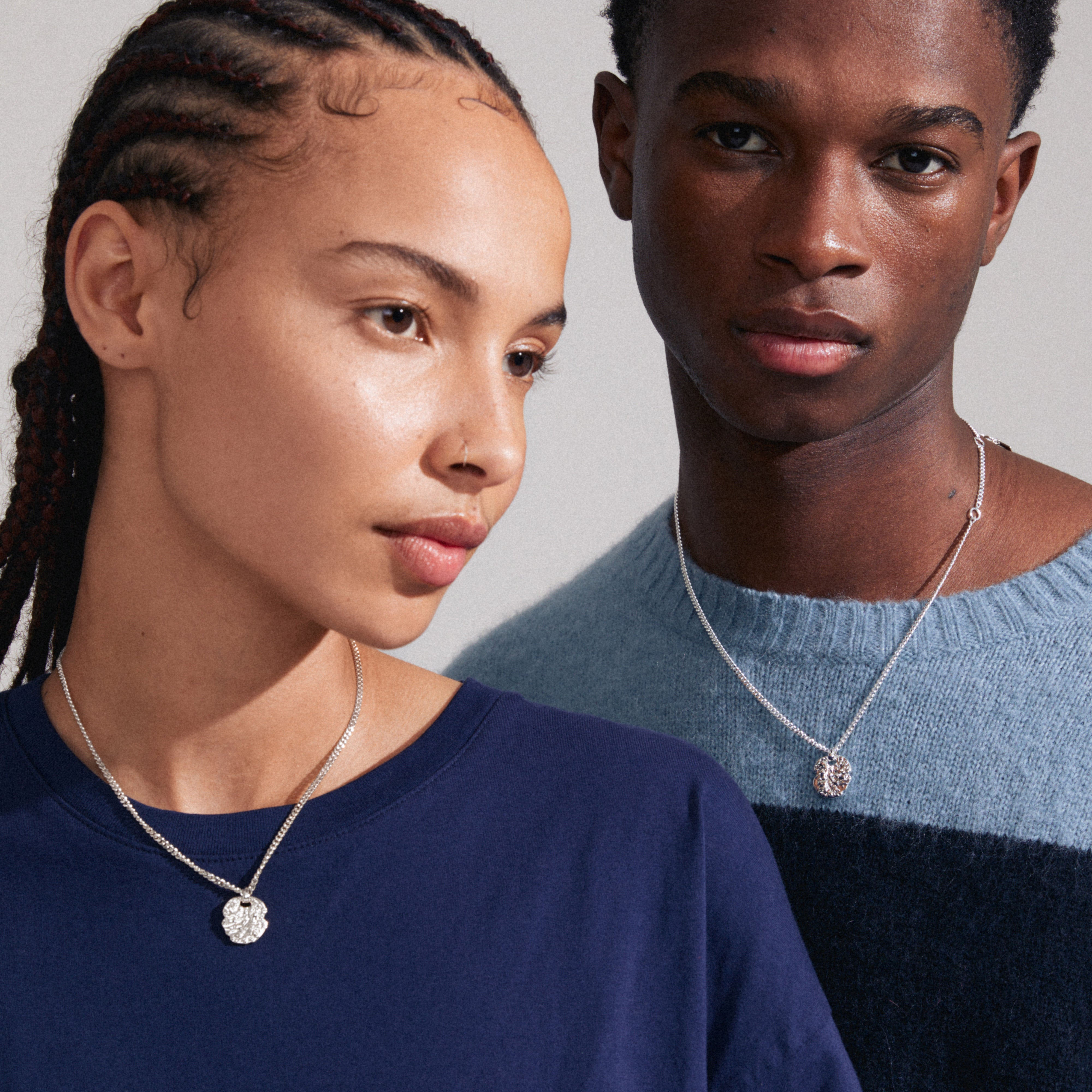 SCOTTIE coin necklace silver-plated on a person, showcasing its rustic coin pendant and sleek curb chain design, highlighting Pilgrim's sustainable, genderless style.