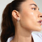 JOLANTA earrings silver-plated: Woman wearing silver-plated bow earrings with Preciosa crystals, showcasing a trendy, elegant look suitable for casual and formal occasions.