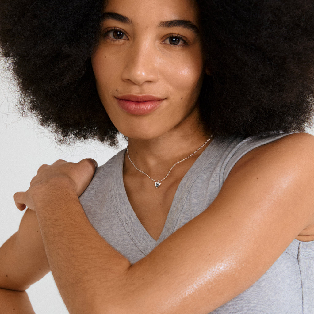 ALAIA necklace: Slim silver-plated chain with a petite heart pendant, crafted from 99% recycled materials. Perfect for layering or standalone elegance.