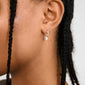 ALAIA earrings silver-plated, featuring versatile huggie hoops with detachable heart pendants, embody a romantic, modern design crafted from 99% recycled material for everyday elegance.