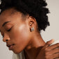 LONA chunky crystal huggie hoops, gold-plated, elegantly adorn a woman's ear, showcasing sparkling Preciosa crystals for a sophisticated, eco-friendly style.