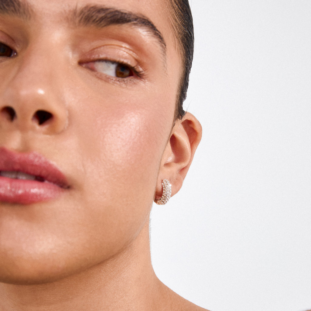 LONA chunky crystal huggie hoops, silver-plated, sparkle on a smooth ear, highlighting glam sophistication with Preciosa crystals, crafted from 98% recycled materials.