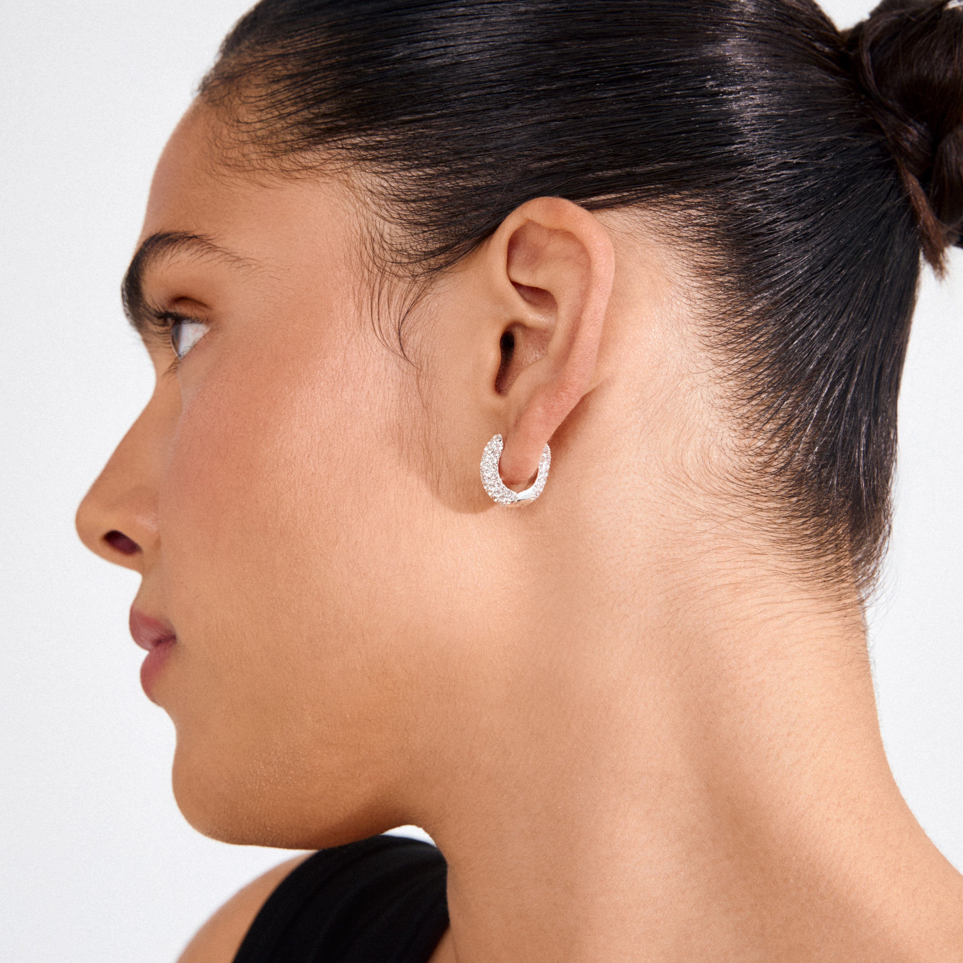 LONA chunky crystal huggie hoops, silver-plated, showcasing sparkling Preciosa crystals on a side profile, highlighting their elegance and recycled craftsmanship.