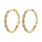Gold-plated EZO twirled crystal hoops featuring fine twisted details and Preciosa crystals, showcasing a braided silhouette with a smart click lock for easy wear.