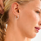 Side profile of a woman showcasing Pilgrim's EZO twirled crystal hoops silver-plated, featuring textured details and Preciosa crystals, highlighting elegance and timeless style.