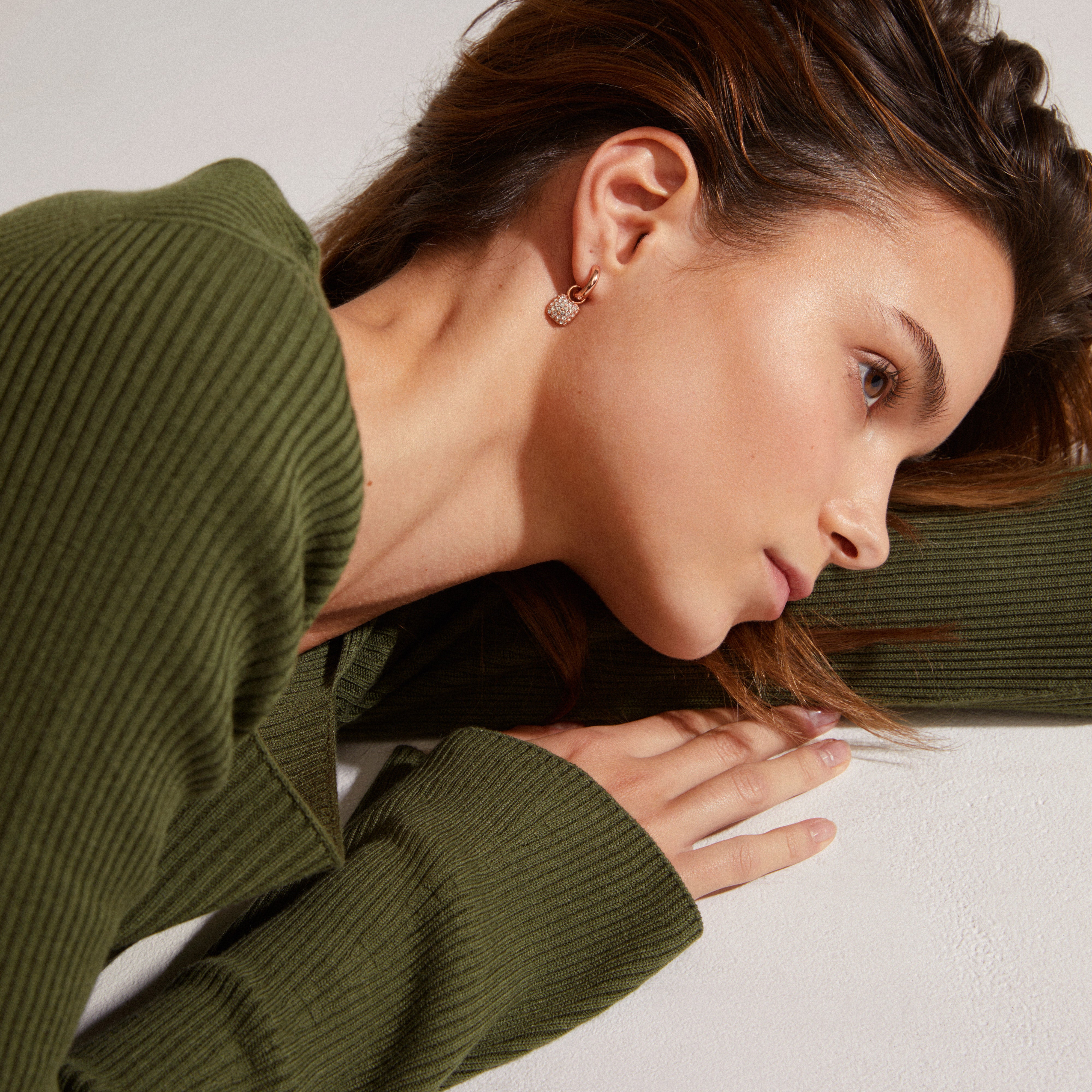 CINDY crystal hoop earrings in rose gold-plated design, featuring sparkling Preciosa crystals, showcased on a woman's ear. Elegant and eco-friendly from Pilgrim.