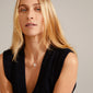 CINDY crystal pendant necklace, silver-plated, worn by a woman in a black sweater, showcasing sparkling Preciosa crystals on a 40 cm chain with a 9 cm extension.