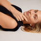 Woman lying down, showcasing the Pilgrim CINDY crystal ring, silver-plated with sparkling Preciosa crystals, enhancing her style with elegance and modern flair.