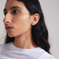 WRENLEY earrings silver-plated, featuring fluid cable chains with sparkling Preciosa crystals, worn by a woman in a white shirt. Classic elegance, perfect for any outfit.