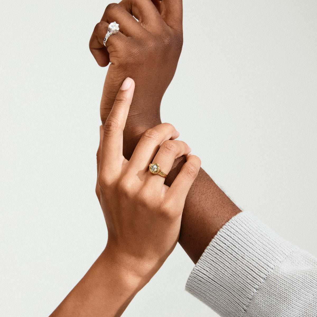 Close-up of hands showcasing the CALLUM ring, a silver-plated accessory with a large Preciosa crystal in an organic bezel, highlighting its unique, handcrafted elegance.