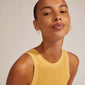 EANNA large hoops gold-plated, worn by a woman, highlighted in a close-up. These timeless, elegant earrings are perfect for creating a unique, stylish look.
