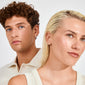 EANN small hoops silver-plated adorn a curly-haired man and a blond woman, showcasing their versatile elegance and minimalist style in a studio portrait.