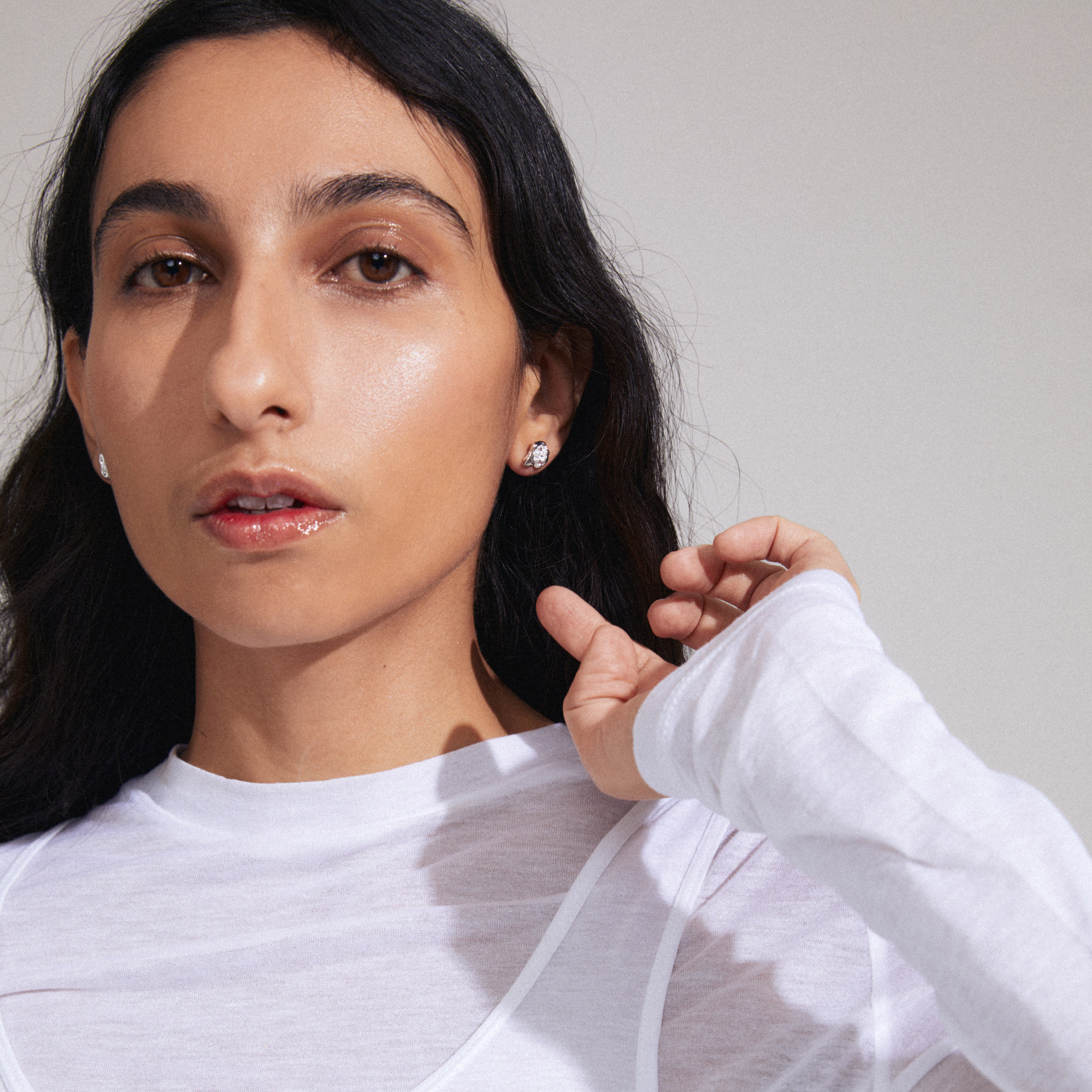 INAYA earrings silver-plated, featuring abstract seashell design with white bead center, crafted from recycled materials. Ideal for versatile styling and multiple piercings.